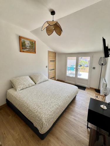 a bedroom with a bed and a ceiling fan at Le Gustave - Proche ville in La Rochelle