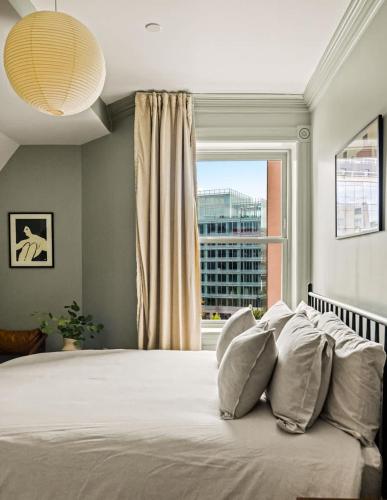 a bedroom with a large bed with a window at Suite 5B at Maison Dupont a Dupont Circle Inn in Washington, D.C.
