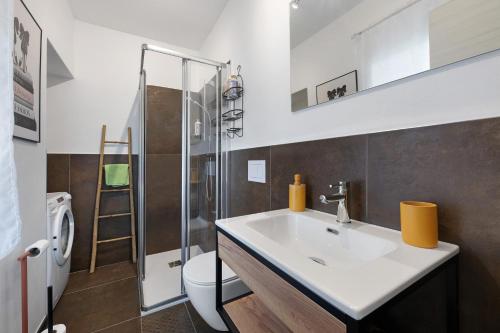a bathroom with a white sink and a toilet at Il Roncaccio Residence Colico in Colico