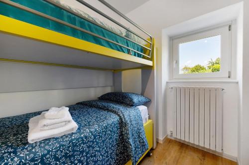 a bedroom with a bunk bed and a window at Il Roncaccio Residence Colico in Colico