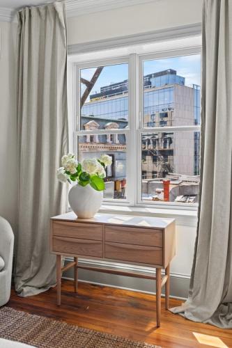 a vase on a table in front of a window at Suite 4C at Maison Dupont a Dupont Circle Inn in Washington, D.C.