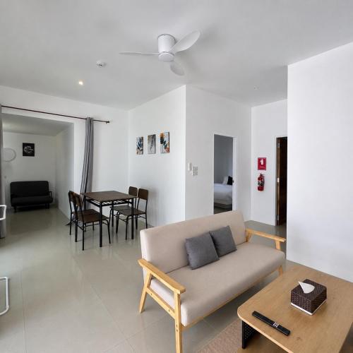 a living room with a couch and a table at Glory Moon Resort in Bophut