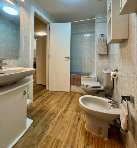 a bathroom with a sink and two toilets in it at Max in Tossa de Mar