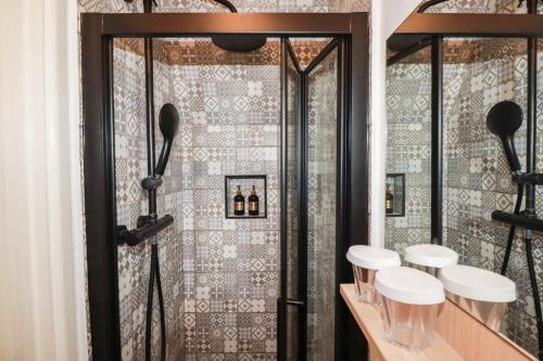 a bathroom with a shower with four toilets in it at Stones Throw in St Austell