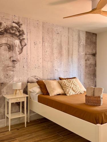 a bedroom with a bed with a head on the wall at Max in Tossa de Mar