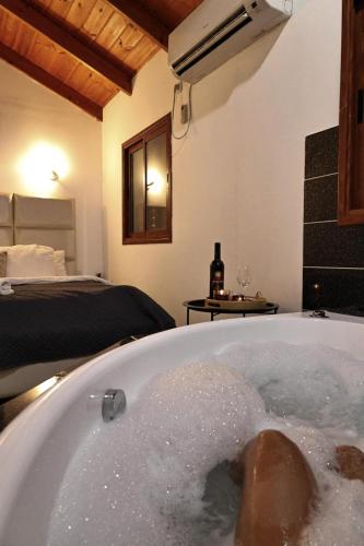 a bathroom with a bath tub filled with water at Orr Halevana in Bruchim Qela' Alon