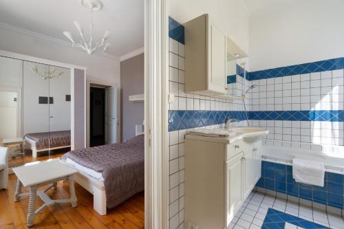 a bathroom with a sink and a tub and a bed at Domaine De La Perthuiserie in Saint-Porchaire