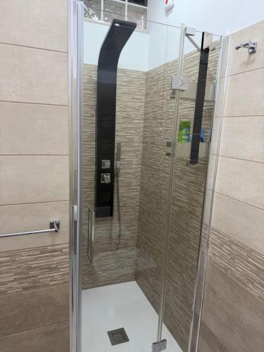 a shower with a glass door in a bathroom at La Stella dei Venti in Scilla