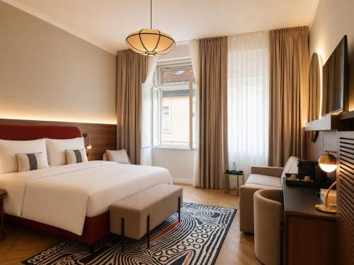 a hotel room with a bed and a couch at Carlton Boutique Hotel - NEW OPENING in Vienna