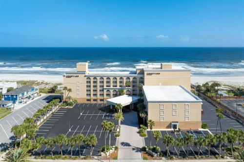 an aerial view of a hotel and the beach at Courtyard by Marriott Jacksonville Beach Oceanfront in Jacksonville Beach