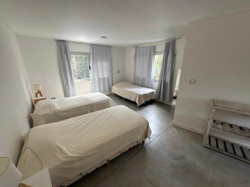 a bedroom with two beds and a fireplace at Casa Benito - Barrio Privado con Piscina en Chapadmalal in Mar del Plata