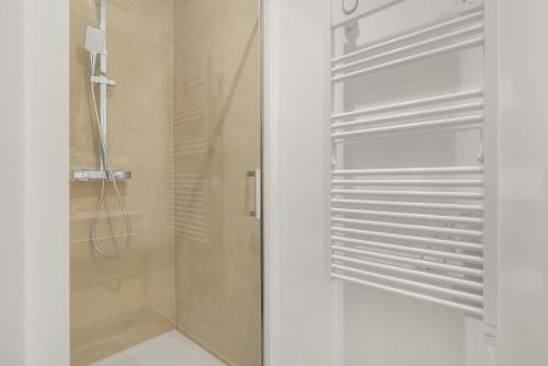 a bathroom with a shower with a glass door at apt hospital in Tourrettes-sur-Loup
