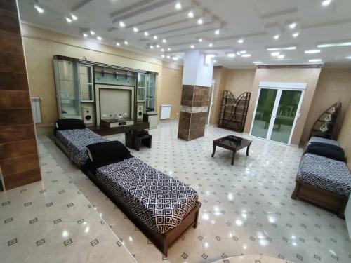 a large room with two beds and a tv at Villa skikda in Skikda