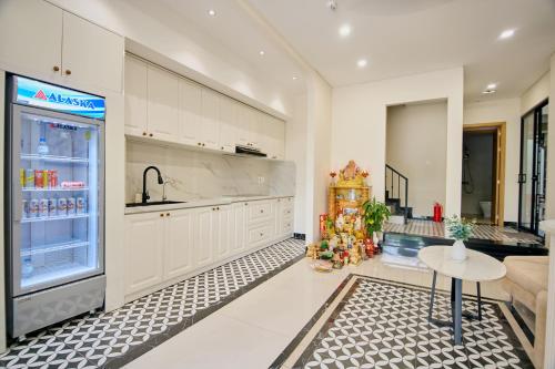 a kitchen with a refrigerator and a table in it at Maison Hin in Hoi An