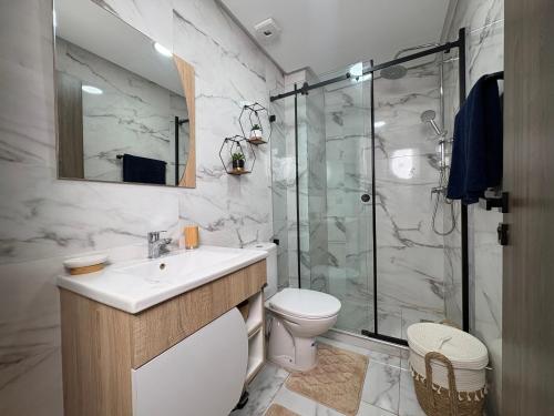 a bathroom with a toilet and a sink and a shower at Nakhla in Dar Bouazza