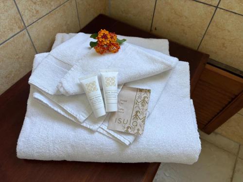 a pile of towels on a table in a bathroom at Hotel Baia Cea in Bari Sardo