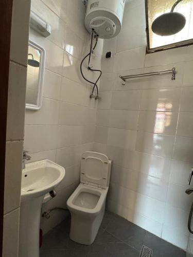 a bathroom with a toilet and a sink at Cozy home with a generator and Wi-Fi in Kinshasa