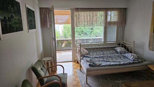 a bedroom with a bed in front of a window at Savonlinnan keskusta in Savonlinna