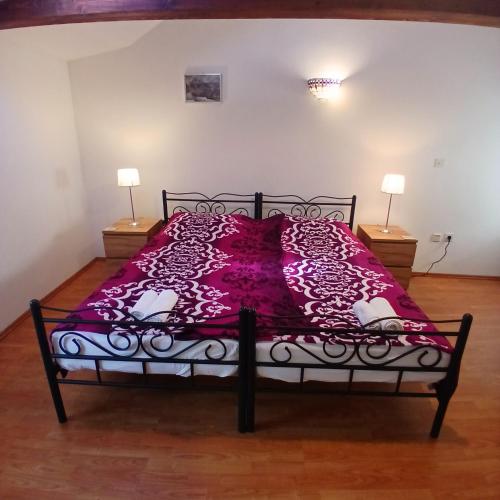 a bedroom with a bed with a purple comforter at Original Mediterranean house in Vodnjan