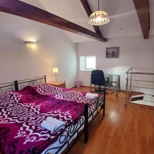 a bedroom with a bed and a chair in it at Original Mediterranean house in Vodnjan