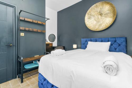 a bedroom with a large bed and a mirror on the wall at G Eighty Four in London