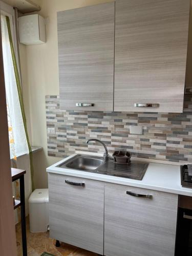 a kitchen with a sink and a counter top at Nicole's House in Asti