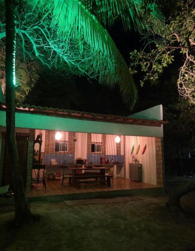 a house with a table in the yard at night at Tapioca Vila Boutique in Atins