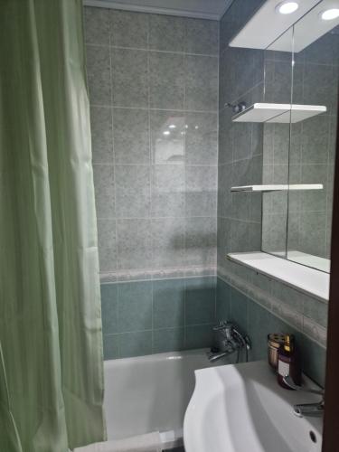 a bathroom with a shower and a tub and a sink at Three Rooms Comfort in Chişinău