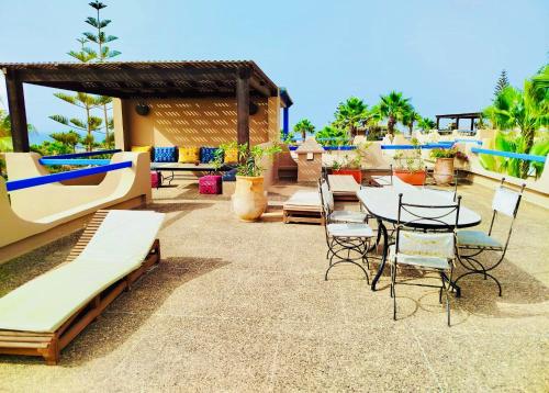 a patio with a table and chairs and a table and chairs at DreamCatcher Homes in Mirleft