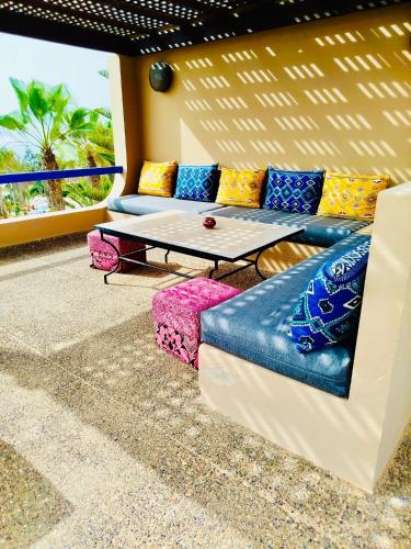 a living room with a couch and a ping pong table at DreamCatcher Homes in Mirleft