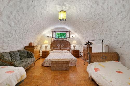 a bedroom with a bed and two chairs in a room at La Lufrerie in Sospel
