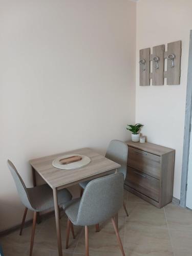 a wooden table with two chairs and a wooden cabinet at Sea&Sunset Studio in Sozopol