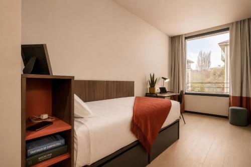 a hotel room with a bed and a window at Lemonade Stays Santiago de Compostela in Santiago de Compostela