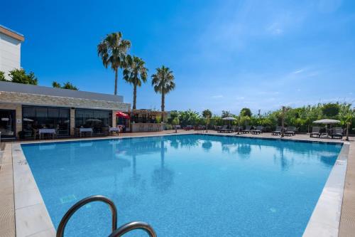 a large swimming pool in front of a building at Laristone Suite Spa Hotel in Antalya