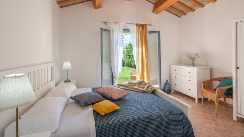 a bedroom with a large bed and a window at Villa Elettra 12&2 by Marche Holiday Villas in San Costanzo