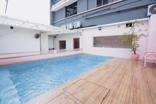 a large swimming pool on the side of a building at Hugstore Pink Hotel in George Town