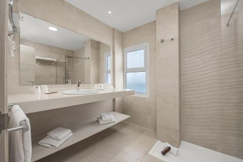 a bathroom with a sink and a shower at Hotel Palia Las Palomas in Torremolinos