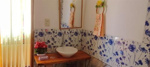 a bathroom with a white bowl on a wooden table at Jardín Andino Hostal in Copacabana