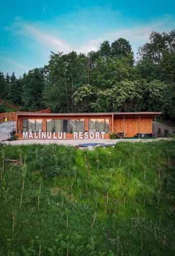 a building with a sign that reads millmutual resort at Mălinului Resort and Spa in Bughea de Sus