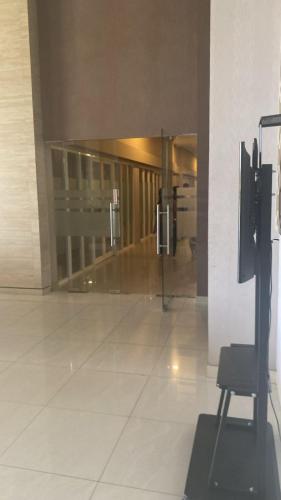 an empty hallway with a chair in a building at Apartemen Gresik in Panggang