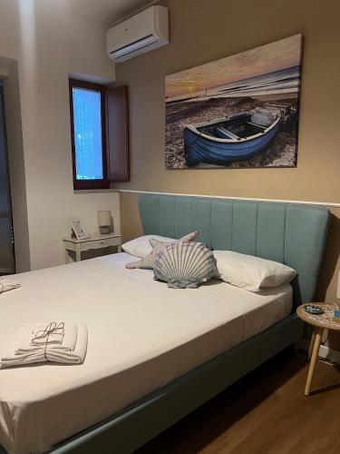a bed with a blue headboard in a bedroom at A-mare Numana in Numana