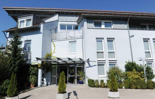 a white building with a lot of windows at Landhotel Gasthof Krone in Kupferzell