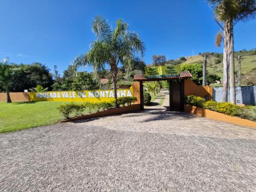 a gate to a house with a sign that readsomedosa wake up no monkey at Pousada Vale da Montanha in Serra Negra