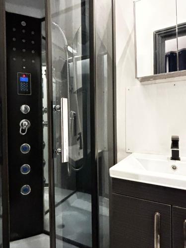 a bathroom with a shower and a sink at G Eighty Four in London