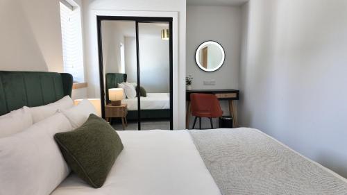 a bedroom with a bed and a mirror and a room at Birch Tree Lodge - Luxurious Lodge on the NC500 by Thrumster Lodges in Wick
