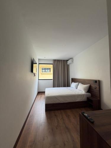 a hotel room with a bed and a window at Nezha Hotel in Tangier