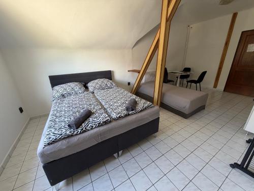 a bedroom with a bed with two baseball bats on it at Dózsa Vendégház in Balatonboglár