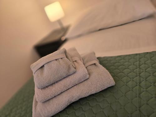 a pile of towels sitting on top of a bed at La Felce in Cernobbio