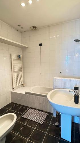 a bathroom with a sink and a tub and a toilet at I mille Tramonti di Ilaria in Livorno