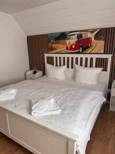 a bedroom with a bed with a van on the wall at Ferienhaus Fehmarnliebe in Fehmarn